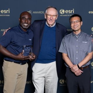 Halff's Sam Amoako-Atta and Zongpei Tang (right) pose with Jack Dangermond (middle) for the 2024 Esri Special Achievement in GIS Award